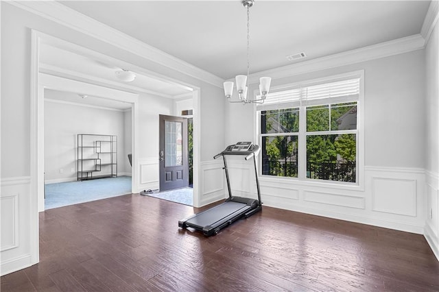 3259 Ivy Crossing Dr, Buford, GA 30519 - workout room featuring a chandelier, wainscoting, crown molding, dark wood-style flooring, and a decorative wall
