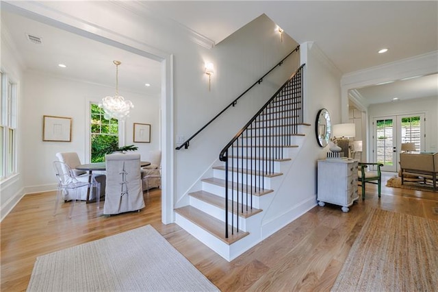 stairs with wood-type flooring and crown molding