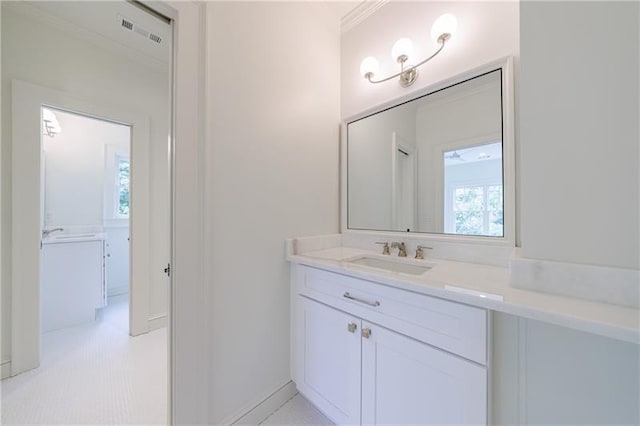 bathroom with vanity and ornamental molding