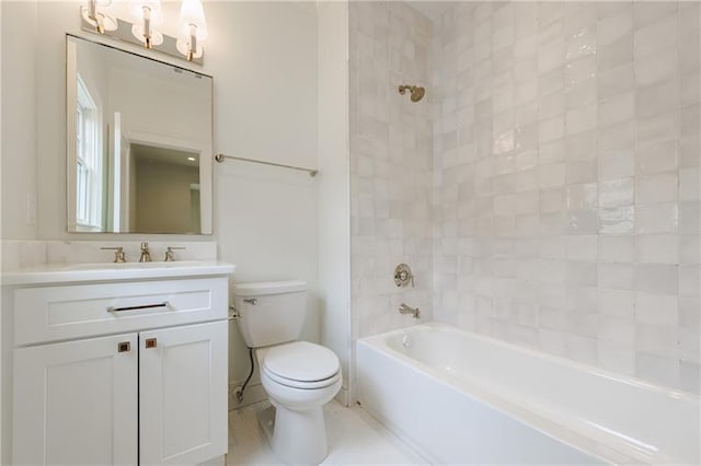 full bathroom with vanity, tiled shower / bath combo, and toilet