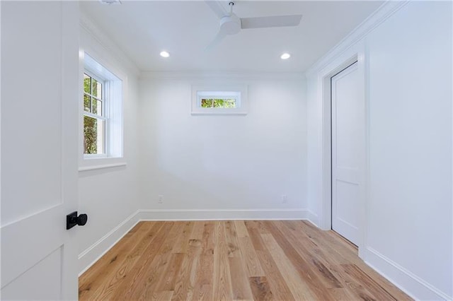 unfurnished room featuring light hardwood / wood-style flooring, ceiling fan, and crown molding