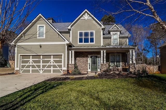 95 Jeffco Dr, Jefferson, GA 30549 - view of front of home with a standing seam roof, concrete driveway, a porch, a garage, and stone siding