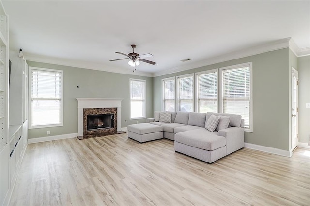 95 Jeffco Dr, Jefferson, GA 30549 - living room with ornamental molding, light wood finished floors, ceiling fan, and a high end fireplace