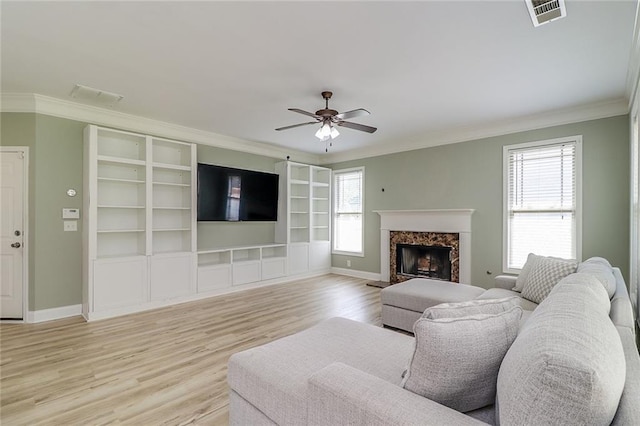 95 Jeffco Dr, Jefferson, GA 30549 - living area featuring ornamental molding, healthy amount of natural light, light wood finished floors, baseboards, and a ceiling fan