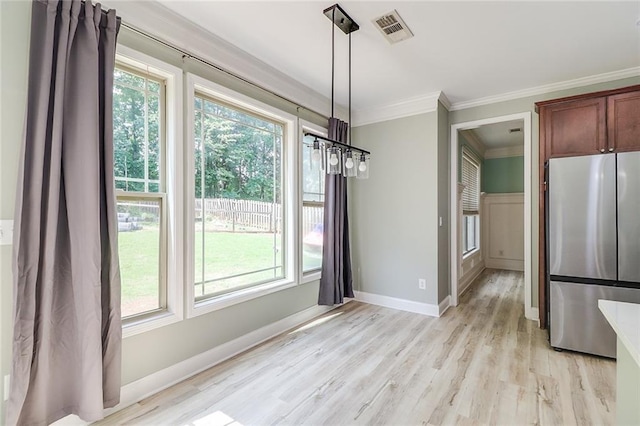 95 Jeffco Dr, Jefferson, GA 30549 - unfurnished dining area featuring ornamental molding, healthy amount of natural light, light wood-style flooring, and baseboards
