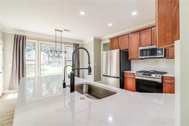 95 Jeffco Dr, Jefferson, GA 30549 - kitchen with stainless steel appliances, ornamental molding, a sink, recessed lighting, and brown cabinetry