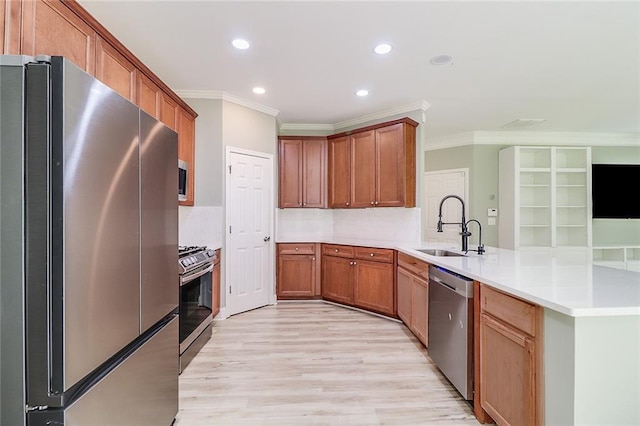 95 Jeffco Dr, Jefferson, GA 30549 - kitchen featuring stainless steel appliances, a sink, a peninsula, ornamental molding, and recessed lighting