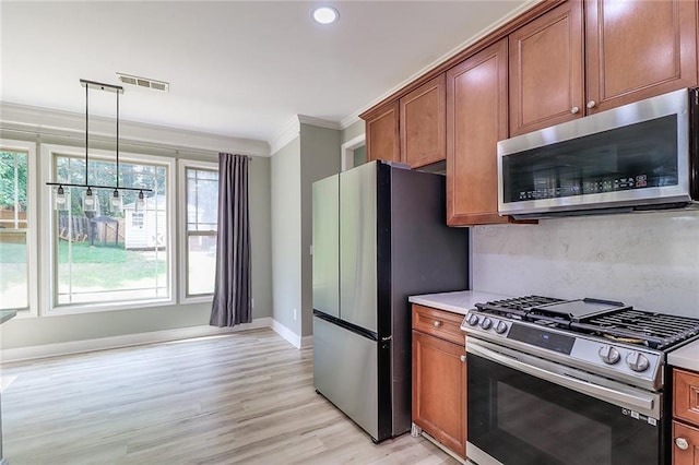 95 Jeffco Dr, Jefferson, GA 30549 - kitchen featuring stainless steel appliances, ornamental molding, brown cabinetry, light wood finished floors, and recessed lighting