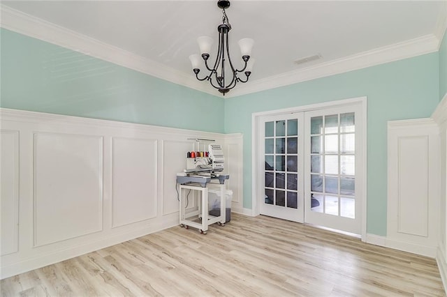 95 Jeffco Dr, Jefferson, GA 30549 - dining area with french doors, light wood-style floors, a decorative wall, ornamental molding, and a chandelier