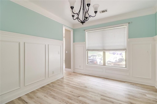 95 Jeffco Dr, Jefferson, GA 30549 - unfurnished dining area with a decorative wall, a chandelier, light wood finished floors, ornamental molding, and wainscoting