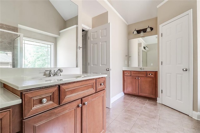 95 Jeffco Dr, Jefferson, GA 30549 - bathroom featuring two vanities, tile patterned flooring, tiled shower, and baseboards
