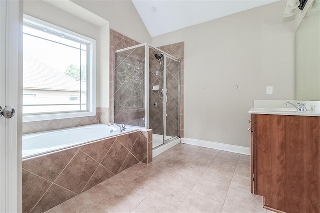 95 Jeffco Dr, Jefferson, GA 30549 - full bathroom featuring vanity, a garden tub, a stall shower, vaulted ceiling, and tile patterned floors