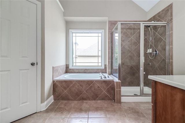 95 Jeffco Dr, Jefferson, GA 30549 - bathroom featuring a garden tub, a stall shower, tile patterned flooring, vanity, and lofted ceiling