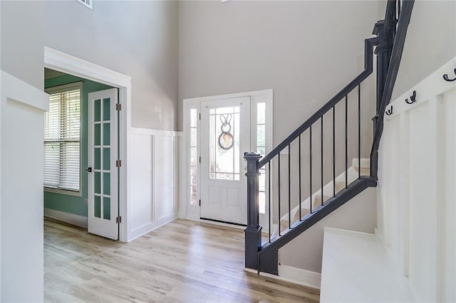 95 Jeffco Dr, Jefferson, GA 30549 - entrance foyer with healthy amount of natural light, wood finished floors, a towering ceiling, and stairs