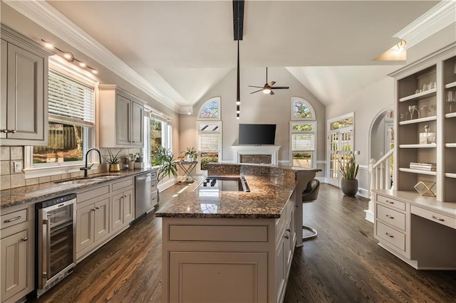kitchen featuring vaulted ceiling, wine cooler, a sink, a ceiling fan, and black electric cooktop