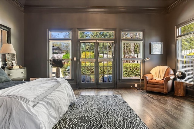bedroom with access to exterior, wood finished floors, and ornamental molding