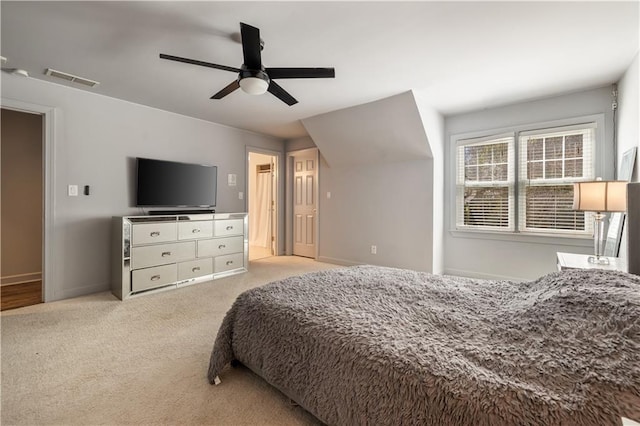 bedroom featuring a ceiling fan, light carpet, baseboards, and visible vents