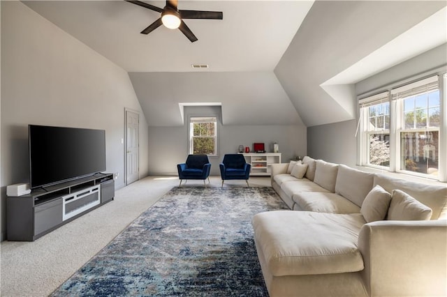 living room featuring lofted ceiling, visible vents, carpet, and a ceiling fan