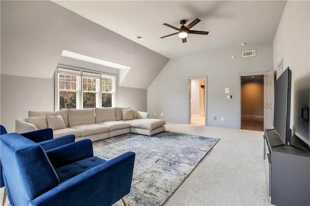 carpeted living room with a ceiling fan, vaulted ceiling, and visible vents