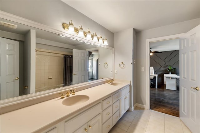 bathroom featuring a shower with curtain, double vanity, tile patterned flooring, and a sink