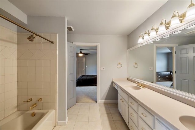 bathroom featuring tile patterned floors, a sink, double vanity, shower / tub combination, and ensuite bathroom
