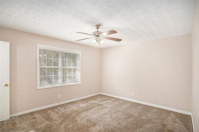 carpeted empty room with a textured ceiling, a ceiling fan, and baseboards