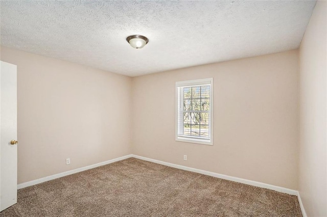 unfurnished room with carpet flooring, a textured ceiling, and baseboards