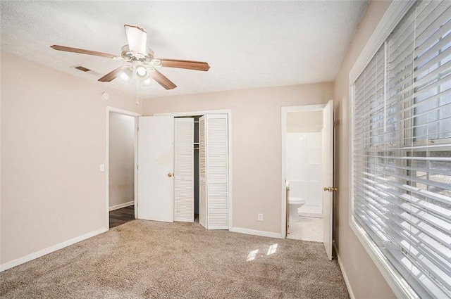 unfurnished bedroom with a ceiling fan, visible vents, baseboards, a closet, and carpet