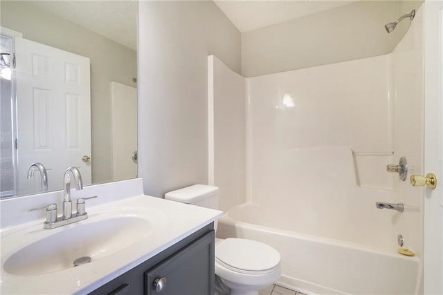 bathroom with tub / shower combination, vanity, toilet, and a textured ceiling