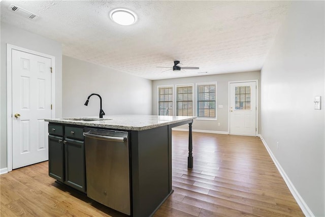 kitchen with a center island with sink, visible vents, dishwasher, wood finished floors, and a sink