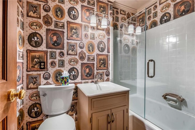 full bath featuring combined bath / shower with glass door, toilet, wallpapered walls, and vanity