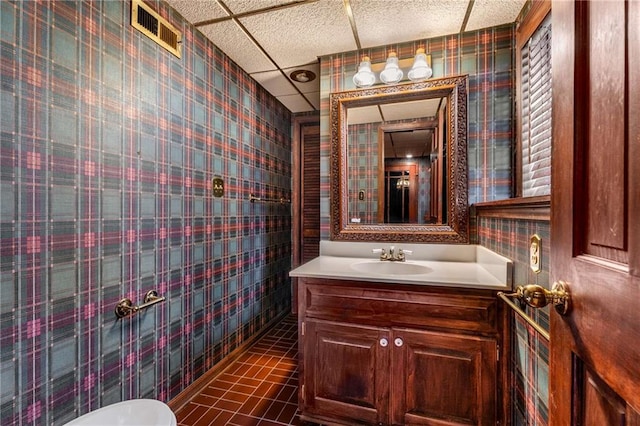 bathroom with vanity, a paneled ceiling, and visible vents