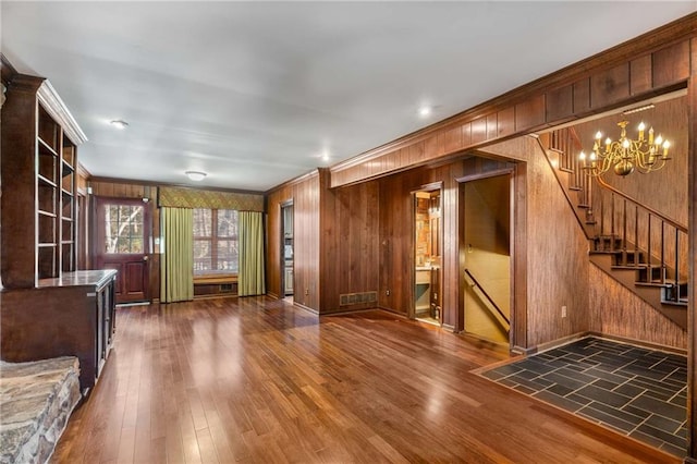 interior space featuring a chandelier, wood finished floors, and crown molding