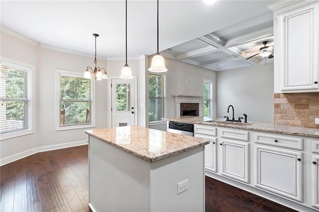 kitchen featuring sink, coffered ceiling, beamed ceiling, and white cabinetry