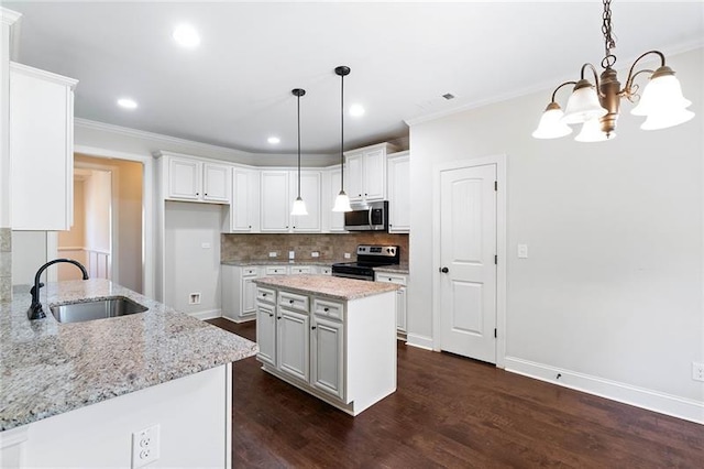 kitchen with sink, white cabinetry, light stone countertops, and appliances with stainless steel finishes