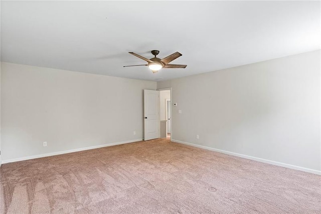 spare room with ceiling fan and light colored carpet