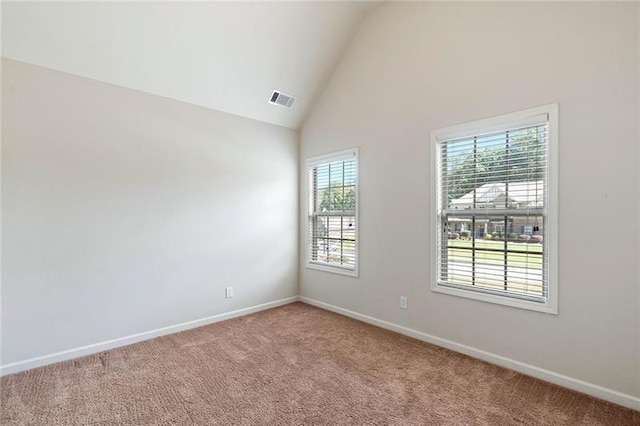 unfurnished room with carpet and vaulted ceiling