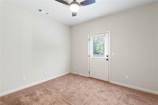 carpeted spare room featuring ceiling fan