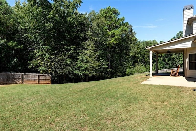 view of yard featuring ceiling fan and a patio area