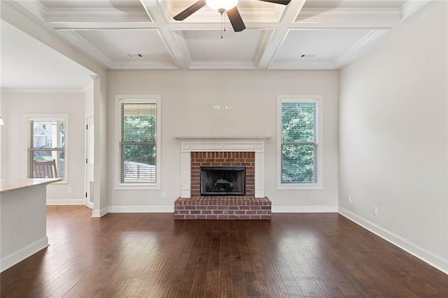 unfurnished living room featuring coffered ceiling, beamed ceiling, and a wealth of natural light