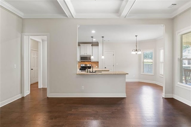 kitchen with hanging light fixtures, white cabinets, beam ceiling, light stone countertops, and stainless steel appliances