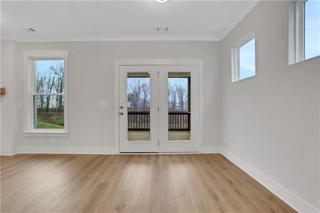 doorway to outside featuring ornamental molding and light hardwood / wood-style floors