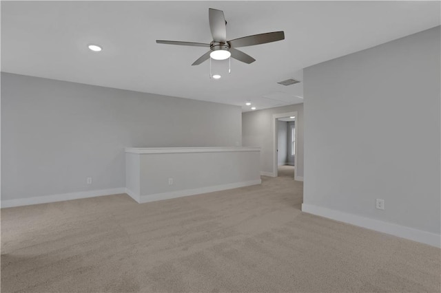 unfurnished room featuring light carpet and ceiling fan