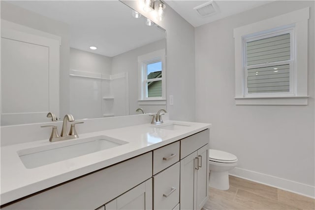 bathroom featuring vanity and toilet