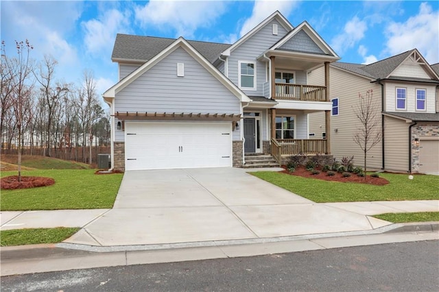 craftsman-style home with a front lawn, a balcony, and covered porch