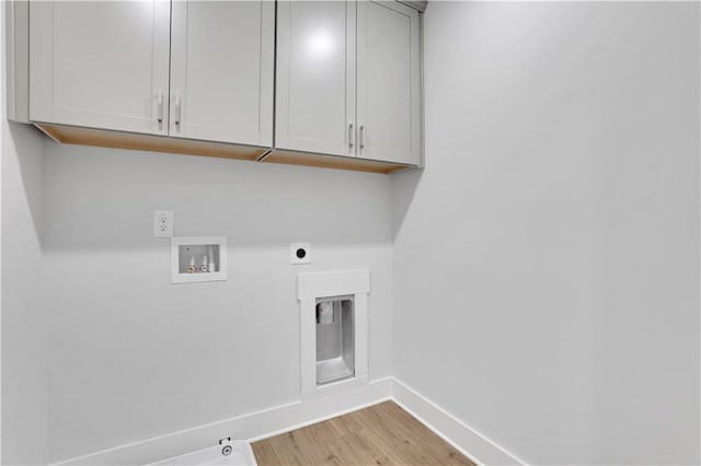 washroom with gas dryer hookup, cabinets, hookup for a washing machine, electric dryer hookup, and light hardwood / wood-style flooring