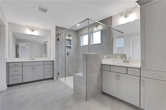 bathroom featuring vanity, an enclosed shower, and tile patterned floors