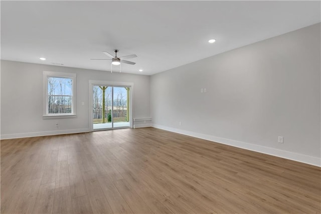 empty room featuring ceiling fan and light hardwood / wood-style flooring