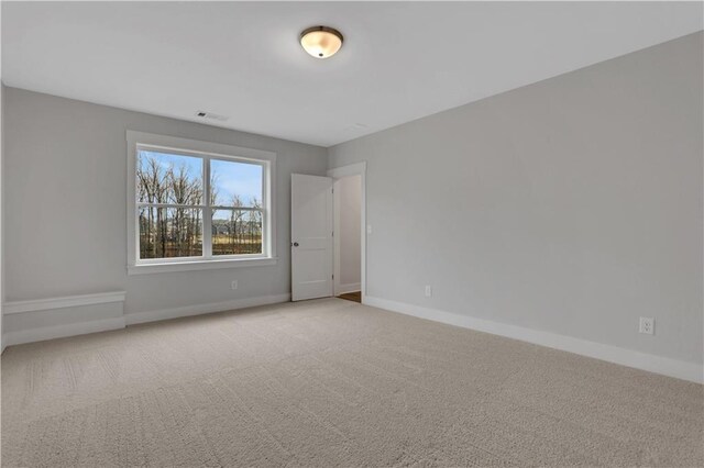 unfurnished bedroom featuring two closets and light colored carpet