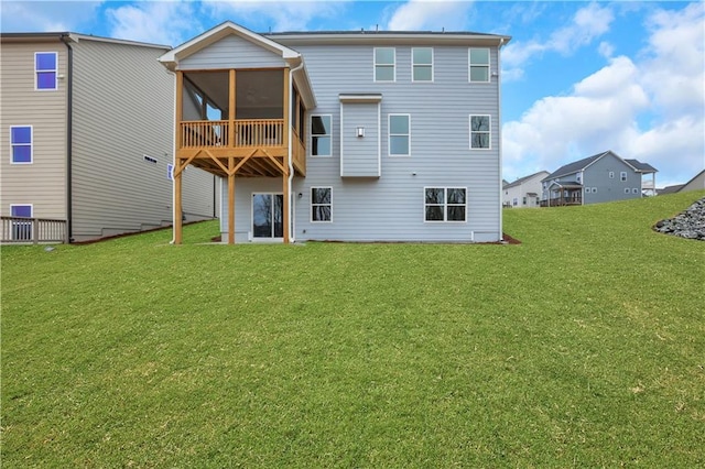 back of property featuring a yard and a sunroom